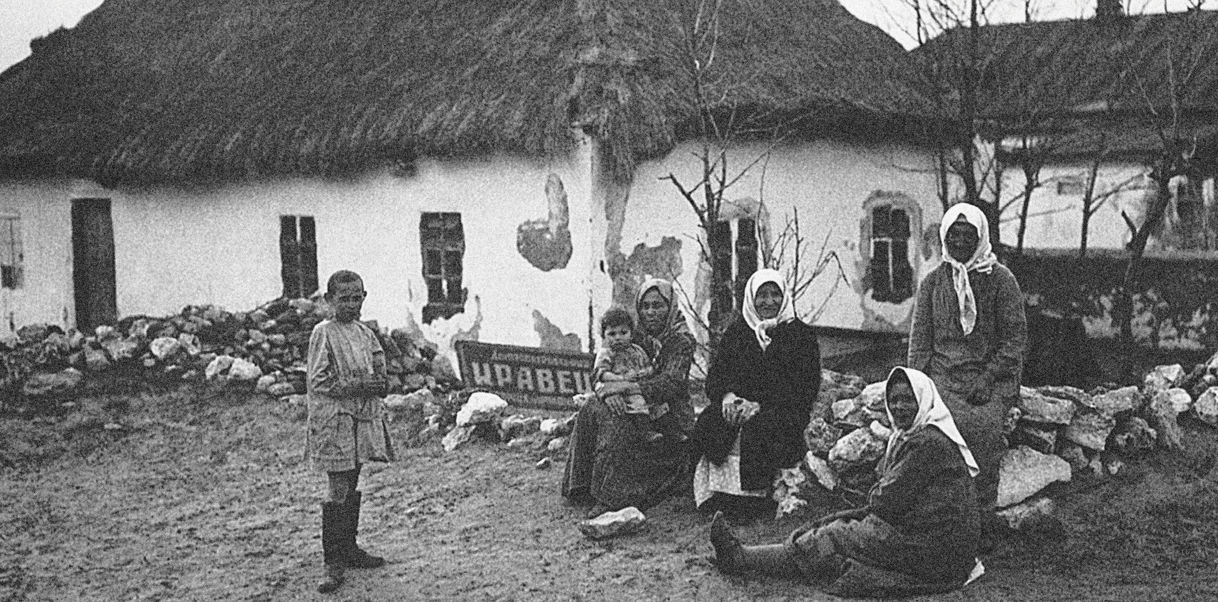 THE DISPOSSESSED KULAKS in front of their confiscated home, Ukraine. 