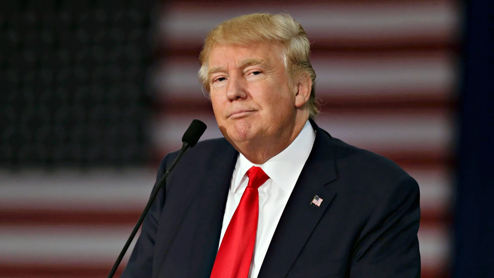 President Trump during interview with American flag background.