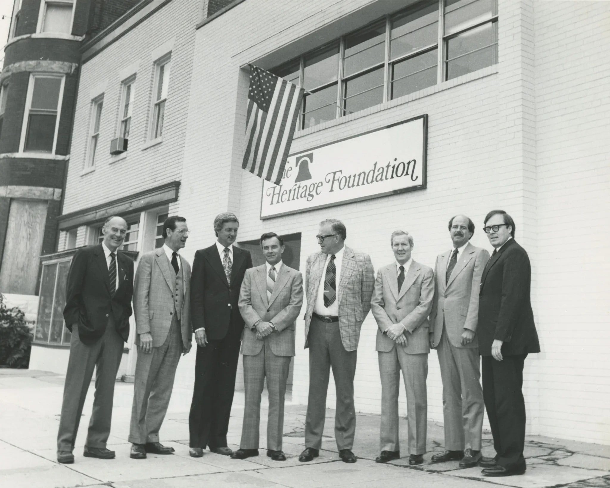 Black and white photo of Heritage founders and original building