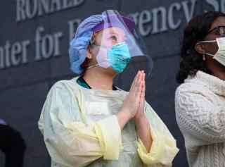 NYU Langone Health workers stand outside with a round of applause for medical staff and essential workers on the front lines of the coronavirus pandemic on April 6, 2020 in New York City.