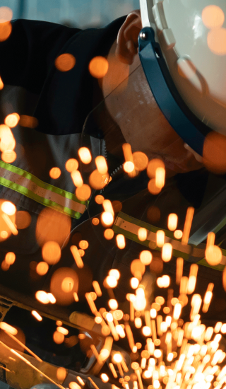 Worker grinding steel